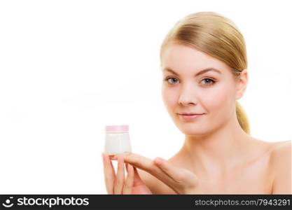 Skincare. Young woman holding cosmetic lotion jar. Blond girl taking care of her dry complexion applying moisturizing cream isolated. Beauty treatment.