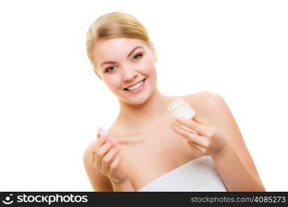 Skincare. Young woman holding lotion jar. Blond girl taking care of her dry complexion applying moisturizing cream isolated. Beauty treatment.