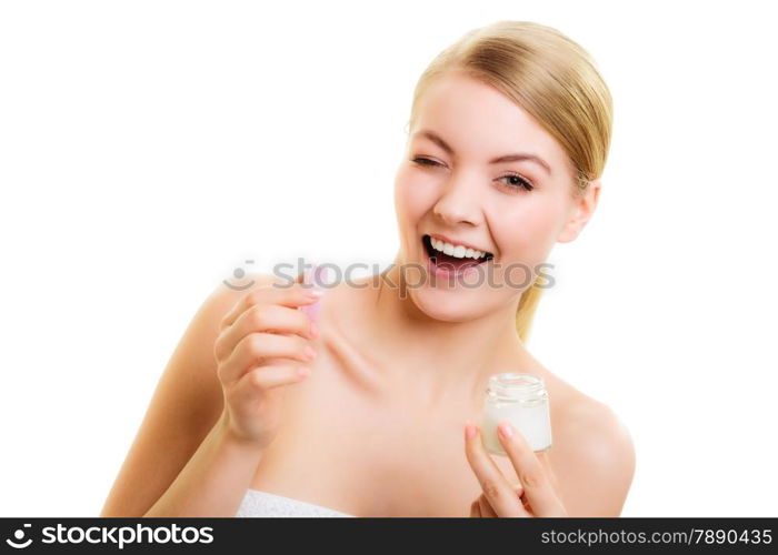 Skincare. Young woman holding lotion jar. Blond girl taking care of her dry complexion applying moisturizing cream isolated. Beauty treatment.