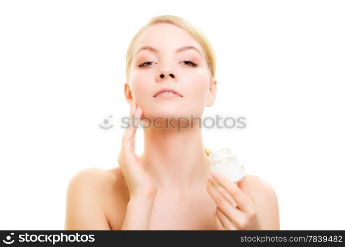 Skincare. Young woman taking care of her dry complexion. Girl applying moisturizing cream isolated. Beauty treatment.