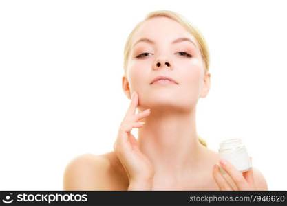 Skincare. Young woman taking care of her dry complexion. Girl applying moisturizing cream isolated. Beauty treatment.