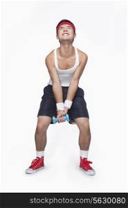 Skinny athlete lifting dumbbells