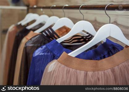 Skirts hang on hanger in fashion store. High quality photo. Clothes, Skirts hang on hanger in fashion store