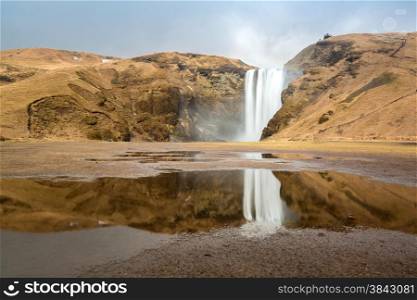 skogafoss waterfall and its reflection on the South of Iceland near the town Skogar