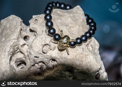 skull figure men bracelet over the rock