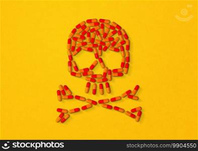 Skull made of orange capsule pills isolated on yellow background. 3D illustration. Skull made of orange capsule pills. Yellow background