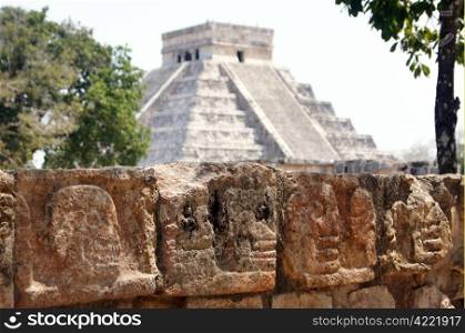 Skulls on the platform and pyramid Kukulkan in Chichen Itza, Yucatan, Mexico
