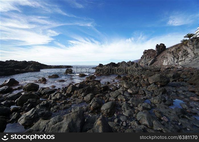 sky above rocks and stony coast. Sea landscape