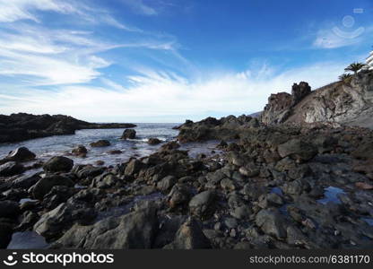 sky above rocks and stony coast. Sea landscape