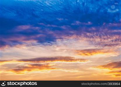 Sky and clouds in the sunset hour. Clouds lit by the setting sun. Blue sky and yellowing clouds at sunset