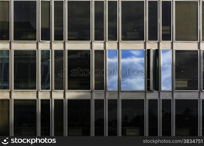 sky and clouds reflected on the windows of a building after a thunderstorm