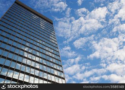 Sky and clouds reflecting in skyscraper windows low angle view