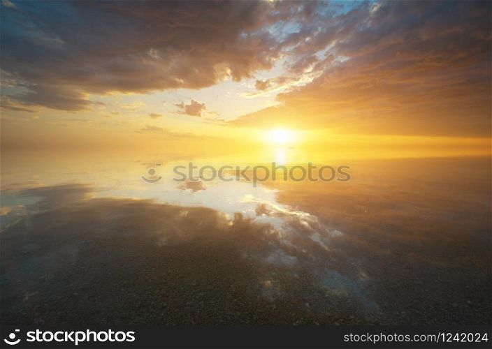 Sky background and sea water reflection on sunset. Nature seascape composition.