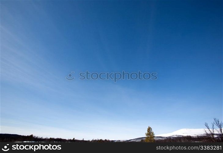 Sky Background, Designers tool - A clear blue sky with slight wisps of clouds