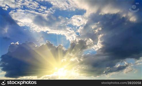 Sky background with dark clouds and bright sunlight