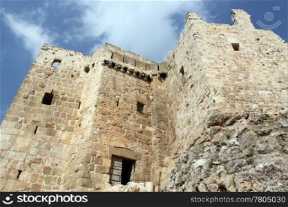 Sky, clouds and wall of stone castle Masyaf in Syria