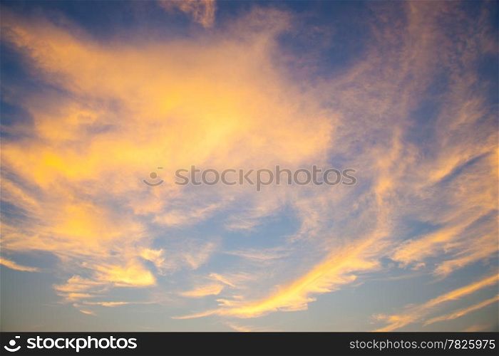 Sky in the evening. Clouds with evening sunlight near the orange. On Sky is blue.