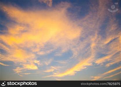 Sky in the evening. Clouds with evening sunlight near the orange. On Sky is blue.