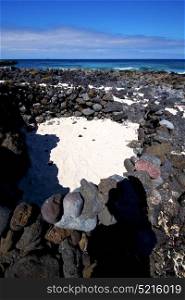 sky light beach water in lanzarote isle foam rock spain landscape stone cloud