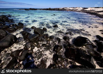 sky light beach water in lanzarote isle foam rock spain landscape stone cloud &#xA;