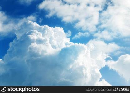 Sky with cumulus clouds and a bright sun close up