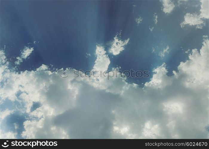 Sky with cumulus clouds and a bright sun close up