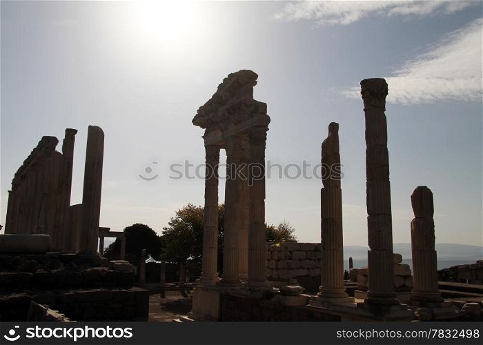 Sky with sun and ruins of Trajan temple in Pergam, Turkey