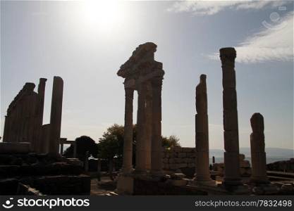 Sky with sun and ruins of Trajan temple in Pergam, Turkey