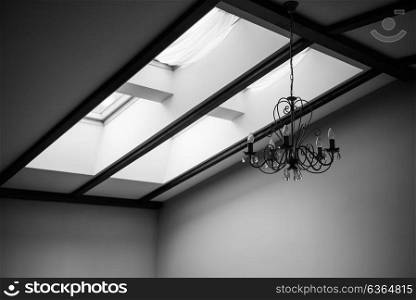 skylights in the roof of the house with a vintage chandelier on the ceiling