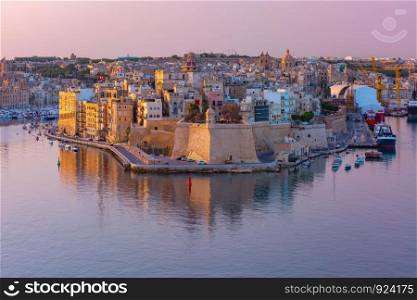 Skyline aerial view of ancient Fort Saint Michael of Senglea peninsula and the Grand Harbor as seen from Valletta at sunrise, Malta.. Grand harbor and Senglea from Valletta, Malta