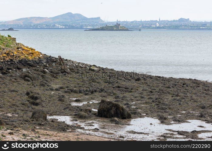 Skyline Edinburgh seen from beach of Inchcolm Island in Firth of Forth. Skyline Edinburgh seen from Inchcolm Island in Firth of Forth