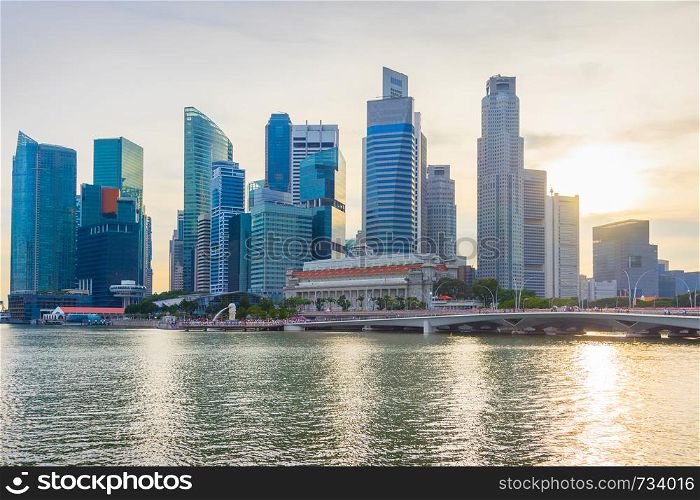 Skyline of Downtown Core of Singapore by the river at sunset