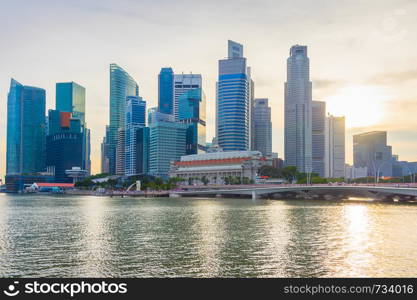 Skyline of Downtown Core of Singapore by the river at sunset