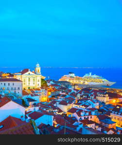 Skyline of Lisbon Old Town. Alfama district, cruise ship. Twilight. Portugal