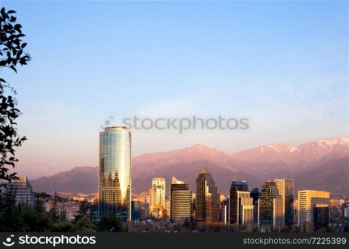 Skyline of Modern buildings in Santiago de Chile with Tha Andes mountain range in the back.