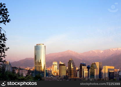 Skyline of Modern buildings in Santiago de Chile with Tha Andes mountain range in the back.