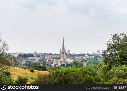 Skyline of Norwich in East England on a cloudy day, with both cathedrals and the castle to be recognised.