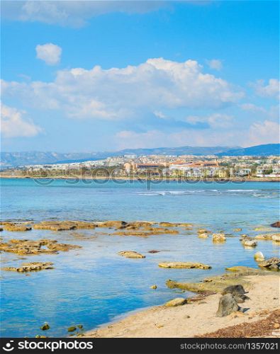 Skyline of Paphos with rocky beach in the foreground, Cyprus