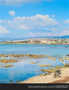Skyline of Paphos with rocky beach in the foreground, Cyprus
