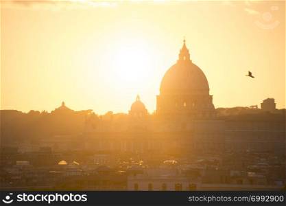 Skyline of Rome with St. Peter Basilica in Vatican at sunset. Italy