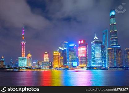 Skyline of Shanghai Downtown at night with reflection in the river