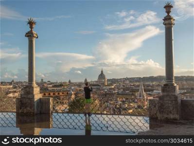 Skyline of the city of Rome, Italy. ROME, ITALY - MARCH 19, 2018: Runner taking selfie of skyline of Rome from the Belvedere terrace. Skyline of the city of Rome, Italy