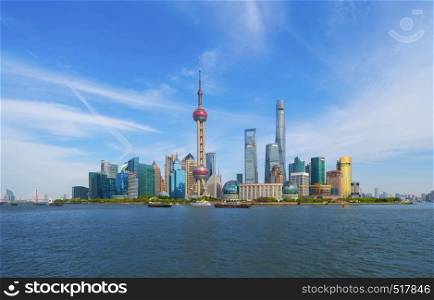 Skyscraper and high-rise office buildings in Shanghai Downtown with blue sky, China. Financial district and business centers in smart city in Asia.