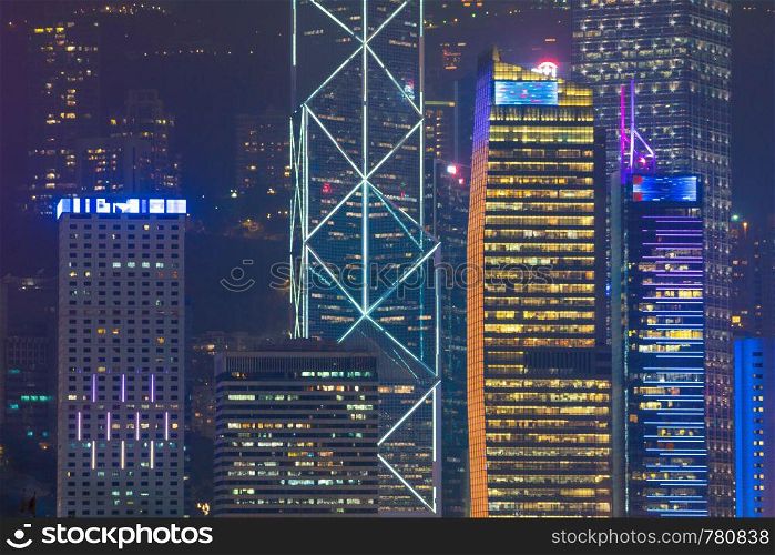 Skyscraper building in Hong Kong city. Building lighting in night.
