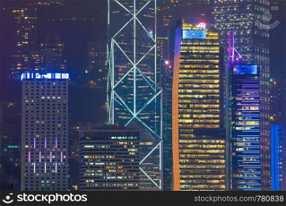 Skyscraper building in Hong Kong city. Building lighting in night.