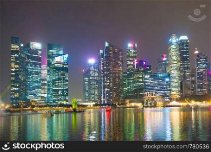 Skyscraper building Singapore city in night. Cityscape skyscraper and business building in Singapore city.