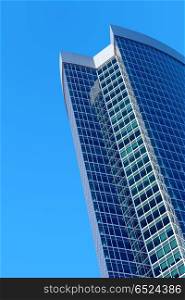 Skyscraper on a background of the blue sky. Modern building