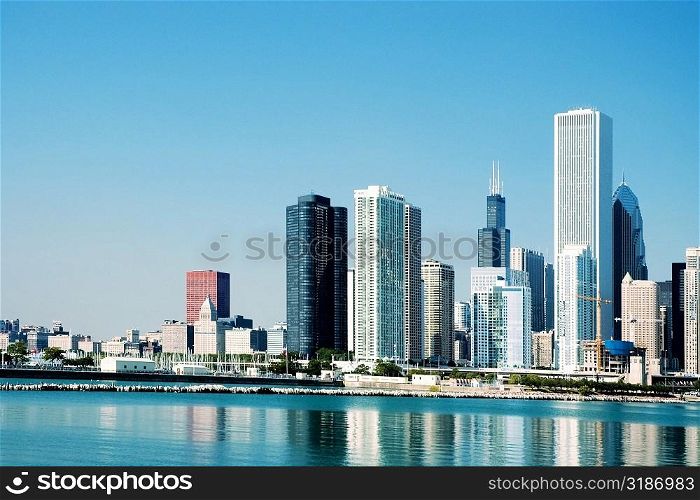 Skyscrapers along a lake, Lake Michigan, Chicago, Illinois, USA