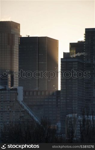 Skyscrapers at sunrise. Sunrise landscape bursting through skyscrapers in city skyline