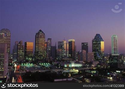 Skyscrapers in a city lit up at dusk, Texas, USA